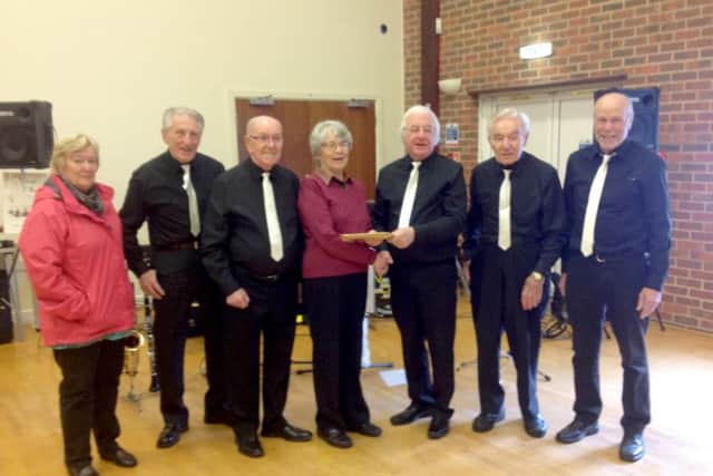Vintage Sounds give a cheque to Macmillan helpers