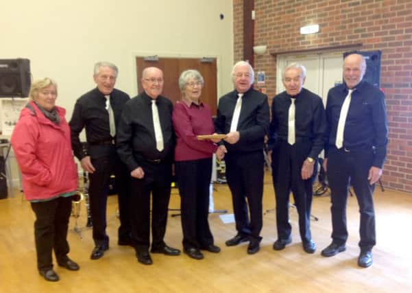 Vintage Sounds give a cheque to Macmillan helpers