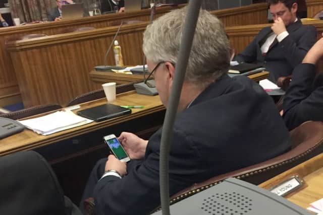 Gerald Vernon-Jackson on his phone playing Solitaire during the latest full council debate in Portsmouth.