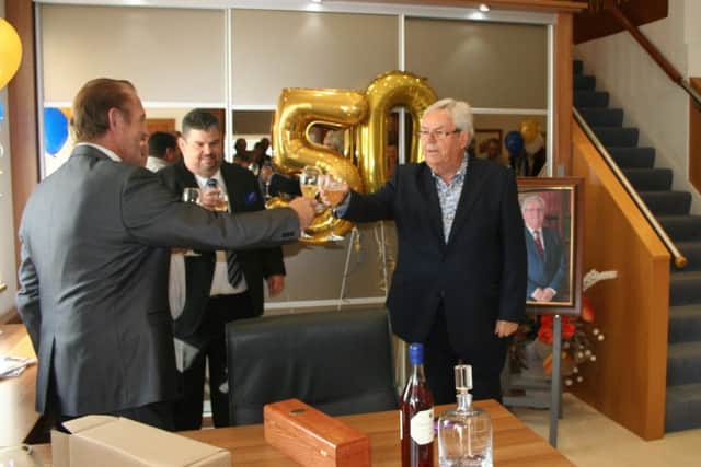 Eric Pollard, Furniture Maker and Designer (left) Jonathan Adey Conquest General Manager (centre) toast Conquest founder John Adey (right) mark 50 years in business at Conquest Fitted Furniture in Farlington PPP-161223-145856001