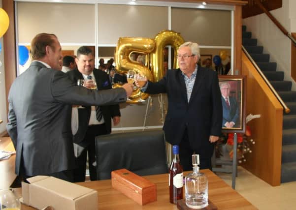 Eric Pollard, Furniture Maker and Designer (left) Jonathan Adey Conquest General Manager (centre) toast Conquest founder John Adey (right) mark 50 years in business at Conquest Fitted Furniture in Farlington PPP-161223-145856001