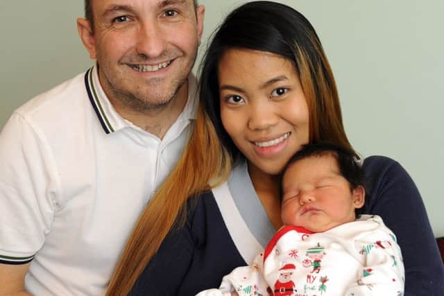 Parents Ian Sims and Rolyn Bayotas with Stanley Picture:  Malcolm Wells (161226-3943)
