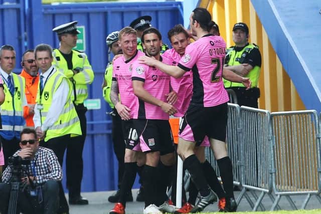 Ricky Holmes and Northampton celebrated winning the League Two title. Picture: Joe Pepler