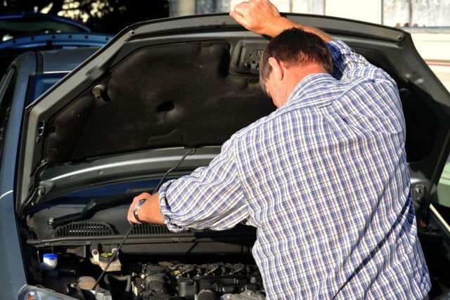 File photo dated 06/10/11 of a man looking under a car bonnet, as motorists were warned they could start 2017 on "a flat note" if they leave their cars idle for too long. PRESS ASSOCIATION Photo. Issue date: Thursday December 29, 2016. The RAC attended nearly 10,000 breakdowns on the first working day of 2016 - up 40% on a typical day - with a third of cases attributed to flat batteries. See PA story TRANSPORT Flat. Photo credit should read: Ian Nicholson/PA Wire TRANSPORT_Flat_071833.JPG