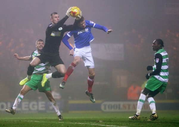 Michael Smith competes for a high ball with Yeovil Town keeper Artur Krysiak. Picture: Joe Pepler