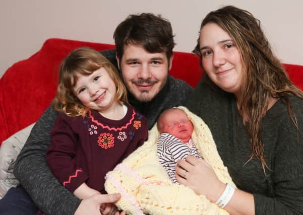 Baby Mabel, who was born at 12.30am on New Year's Day, with her parents Sadie Foster and Joseph Saunders and her sister Nancy, three

 Picture: Habibur Rahman (170003-55)