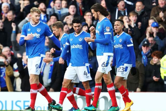 The Pompey players rcongratulate Christian Burgess, second right, after his winner Picture: Joe Pepler