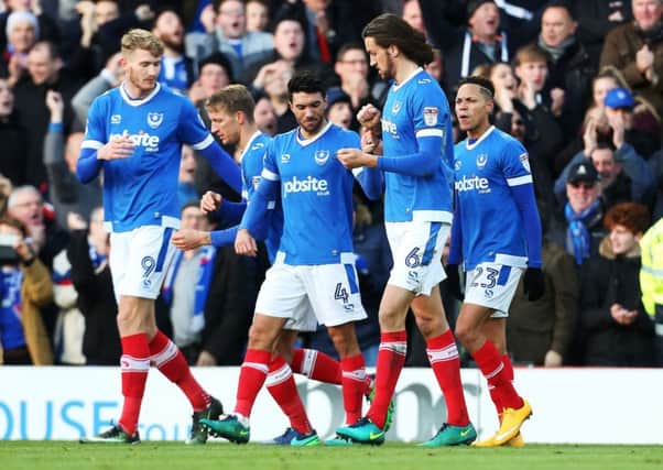 The Pompey players rcongratulate Christian Burgess, second right, after his winner Picture: Joe Pepler