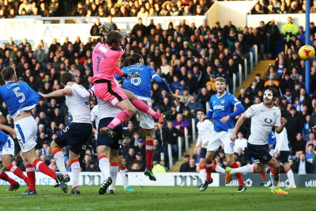 Christian Burgess scores the winner for Pompey with a first-half header Picture: Joe Pepler