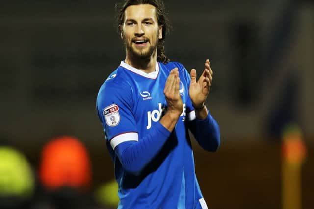 Pompey match-winner Christian Burgess celebrates victory against Luton Picture: Joe Pepler