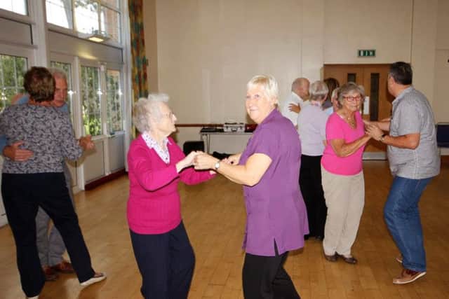 Guests at the dance enjoying themselves on the dance floor and, left, having a singalong