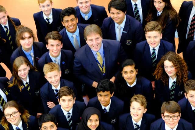 Headteacher Stuart Vaughan celebrates the result with some of the students