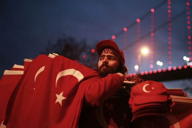 People carrying Turkish flags gather at the scene of the nightclub New Year's Day attack, in Istanbul, Tuesday, Jan. 3, 2017.
AP Photo/Emrah Gurel TURKEY_Nightclub_175289.JPG