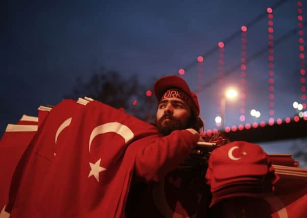 People carrying Turkish flags gather at the scene of the nightclub New Year's Day attack, in Istanbul, Tuesday, Jan. 3, 2017.
AP Photo/Emrah Gurel TURKEY_Nightclub_175289.JPG