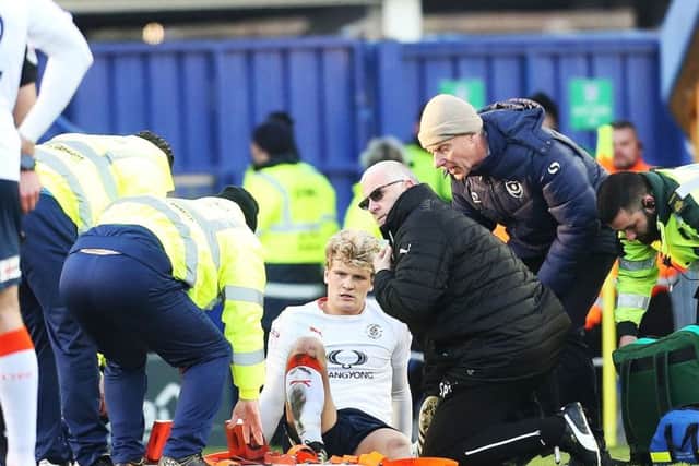 Luton's Cameron McGeehan is stretched off. Picture: Joe Pepler