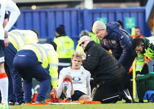 Luton's Cameron McGeehan is stretched off. Picture: Joe Pepler