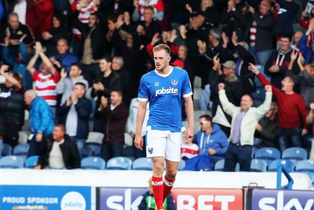Matt Clarke trudges away as Doncaster fans celebrate victory at Fratton Park in October. Picture: Joe Pepler