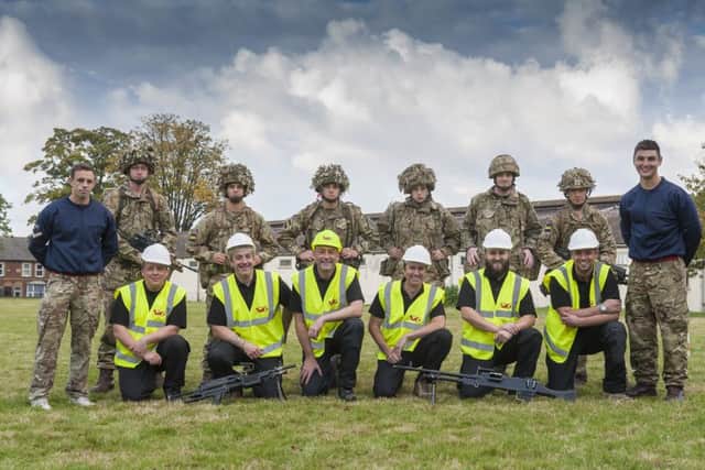 Jamie Anderson, first left kneeling, and James Gardner, first right kneeling, and the SIG team with the Princess of Wales Royal Regiment