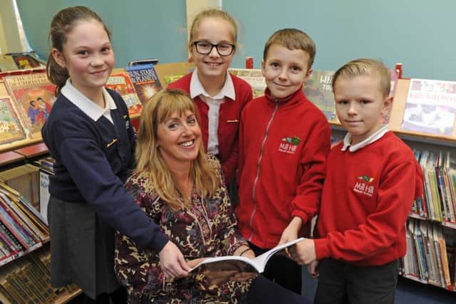 Children's author Kate Rawding at Mill Hill Primary School with, from left, Jessica Alderson, 10, Alexandra Budnaru, nine, Jake Ward, nine, and Danny Budd, nine Picture: Ian Hargreaves (170049-1)