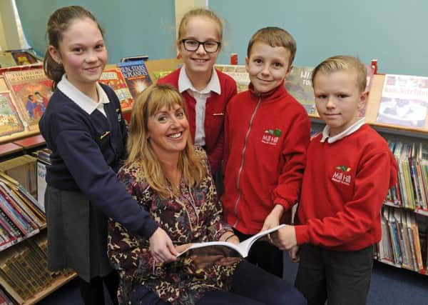 Children's author Kate Rawding at Mill Hill Primary School  with, from left, Jessica Alderson, 10, Alexandra Budnaru, nine, Jake Ward, nine, and Danny Budd, nine Picture: Ian Hargreaves (170049-1)