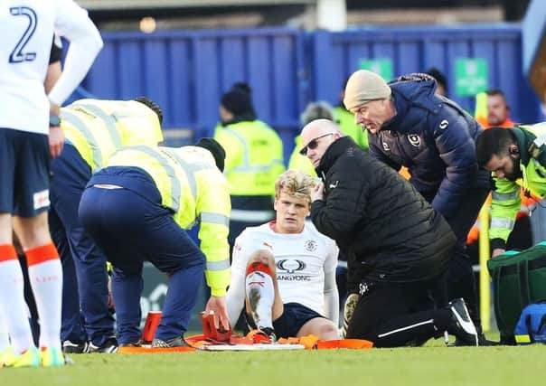 Luton's Cameron McGeehan is stretchered off on Monday. Picture: Joe Pepler