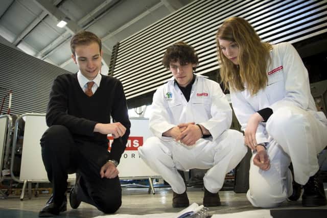 From left, James Scott, Robbie North and Hannah-Lea Barber - apprentices at BAE Systems' Cowes site Picture: BAE Systems