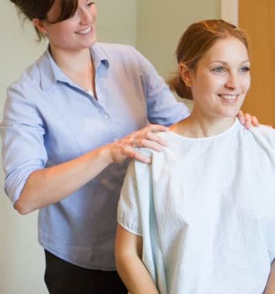 Chiropractor Philippa Oakley with a client in the new premises