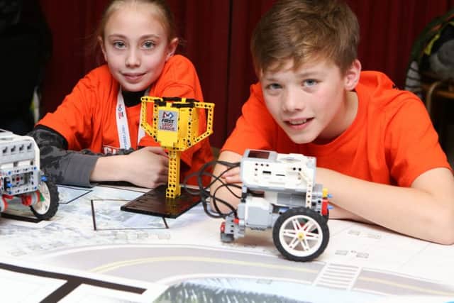 Lottie Conlin and George Mapp, both 11, with their robots and trophy