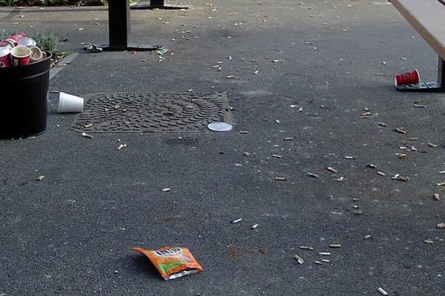 A picture by David Lee of some of the cigarette butts and other rubbish scattered outside the QA