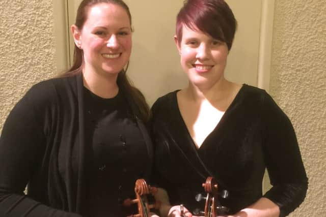 Violinists Louise Holmes, left, and Jen Ansari