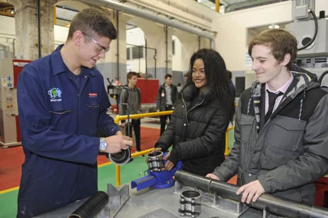 (Left to right) Second year apprentice Owen Cranstone with students Naomi Muyembe and Rob Santy. Picture: Ian Hargreaves (170052-4)