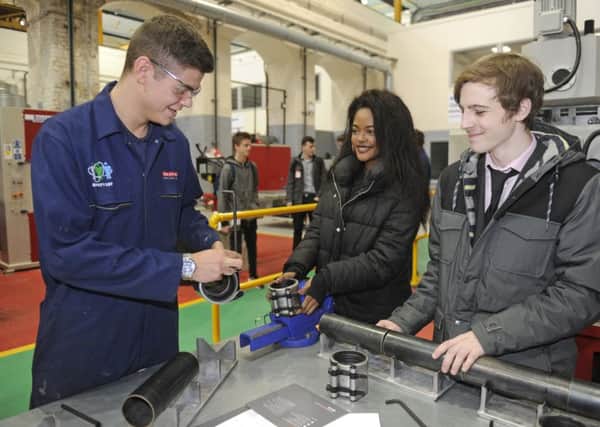 (Left to right) Second year apprentice Owen Cranstone with students Naomi Muyembe and Rob Santy.  Picture: Ian Hargreaves  (170052-4)