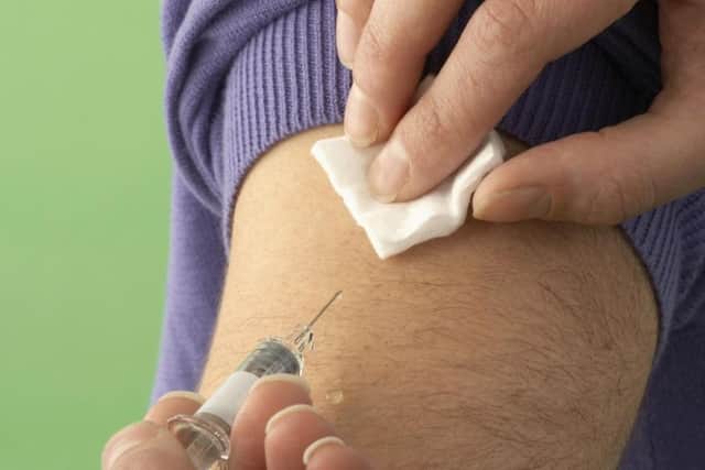 A man receiving a flu jab