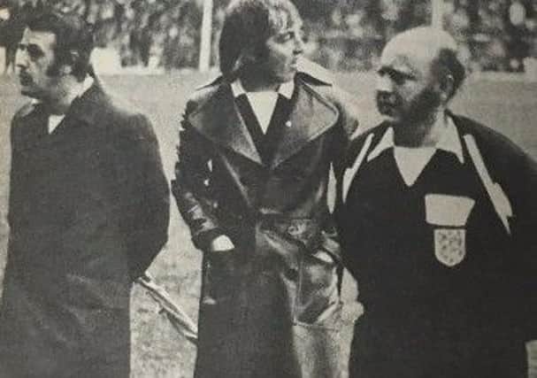 Sartorial elegance came to Fratton Park on Saturday, January 12, 1974, when Mr. Roger Kirkpatrick of Leicester and his two linesmen Mr. J. A. Christopher and Mr. J. C. Roost donned warm clothing after the referee had stopped the game when the floodlights failed