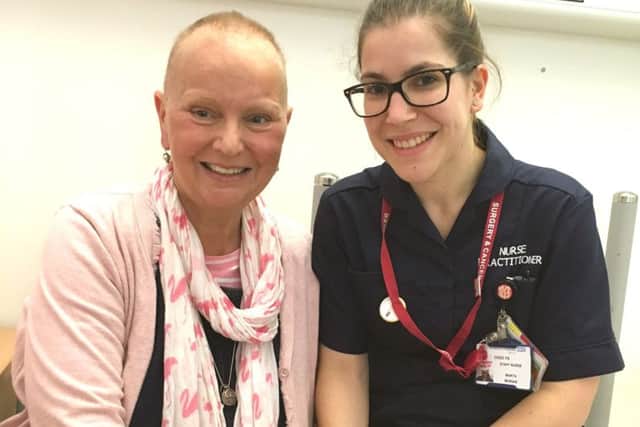 Cancer patient Julie Ankers, left, with Martha Morais, a nurse practitioner for acute oncology at QA Hospital
