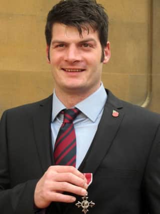 Army veteran Dave Henson collecting his MBE