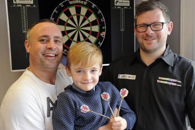 Steve Grant, 40, from Waterlooville with his son Lewie Grant, six, and darts player James Wade.Picture: www.waa.co.uk