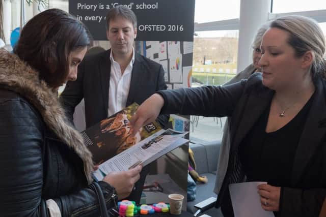 People interested in entering the teaching profession attended a recruitment event at 1000 Lakeside North Harbour on Saturday. Hayley Sweeney from Portsmouth, who is interested in teaching science, discusses the prospectus with Ellie Moore, science teacher at  Priory School, Southsea. In the background is Head Teacher Stewart Vaughan. Picture: Keith Woodland.