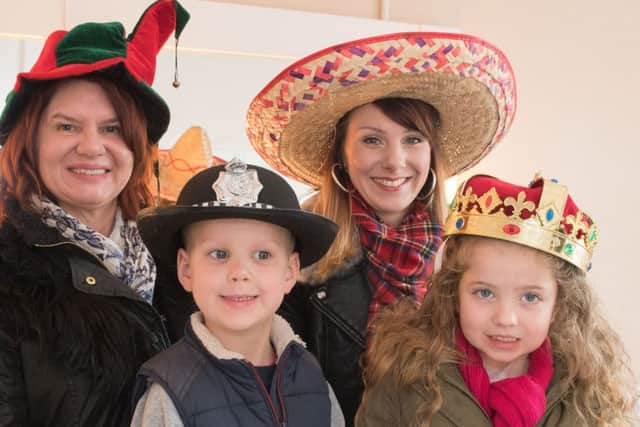 The Kings Theatre, Southsea, held an Open Day giving members of the public an oppourtunity to explore areas usually off limits and find out more about the theatre. - left to right - Tracey Bows, Archie Earl Jade Earl and Scarlett Earl try on some of the costume hats. Pictures: Keith Woodland