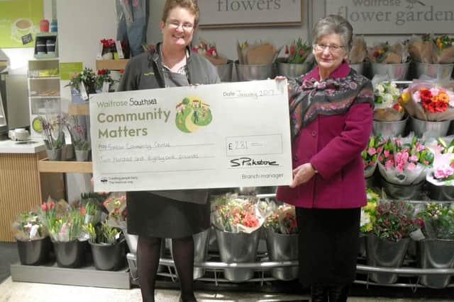 Alice Laurie, from Waitrose, hands a cheque to Kay Ackerman, from Fratton Community Centre