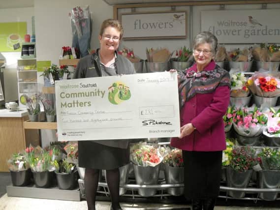 Alice Laurie, from Waitrose, hands a cheque to Kay Ackerman, from Fratton Community Centre