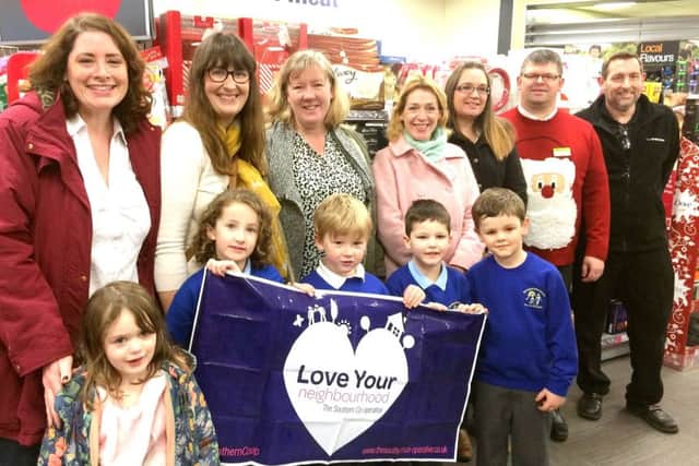 Parents, teachers and pupils from Denmead Infants School with staff from the village Co-op