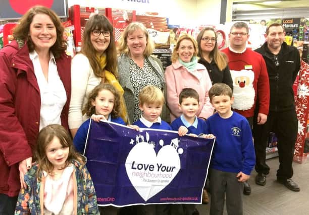 Parents, teachers and pupils from Denmead Infants School with staff from the village Co-op