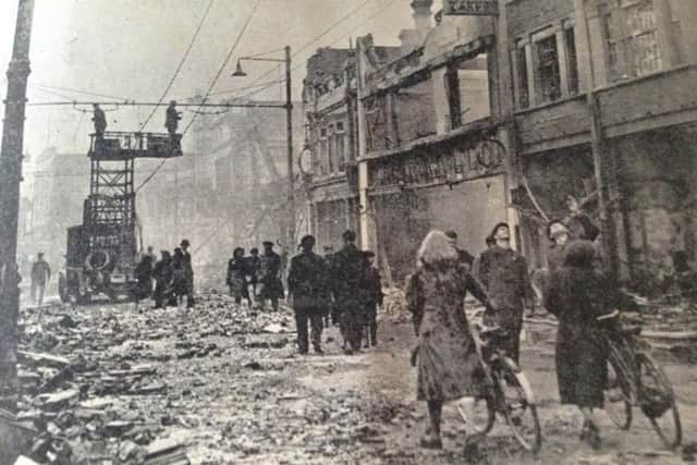 LIFE GOES ON The wreckage in Commercial Road