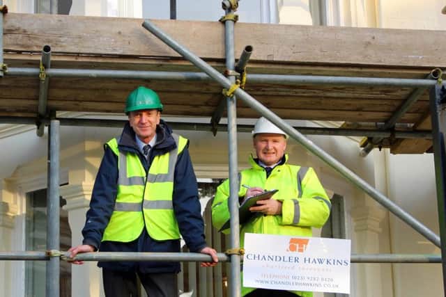 Peter Chandler, left, and Neil Hawkins of chartered surveyors Chandler Hawkins, on scaffolding outside their headquarters in Landport Terrace, Portsmouth