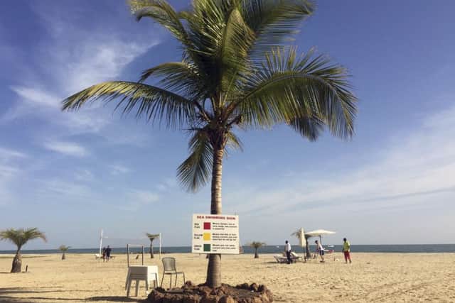 Tourists lay on the beach in Gambia's capital Banjul