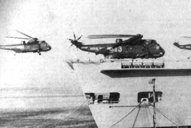 Sea King helicopters of 820 Naval Air Squadron one of them piloted by Prince Andrew land aboard HMS invincible in Portsmouth Naval Base (5211-1)