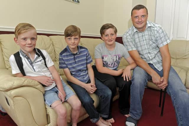 From left, Sam Merrick with his brothers Liam, 10, Kiran, 11, and dad Paul Picture: Ian Hargreaves