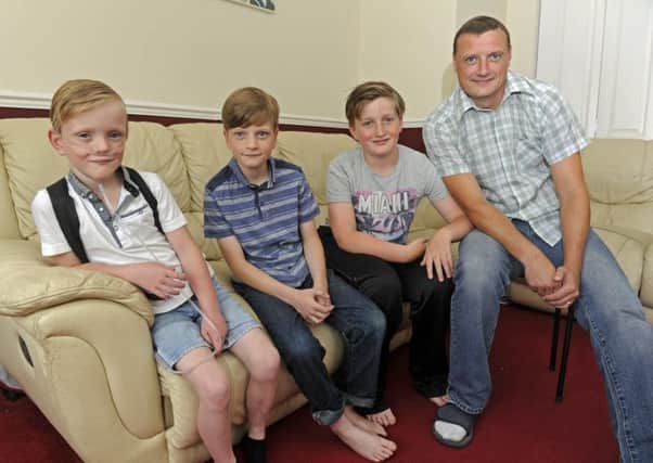 From left, Sam Merrick with his brothers Liam, 10, Kiran, 11, and dad Paul 
Picture: Ian Hargreaves
