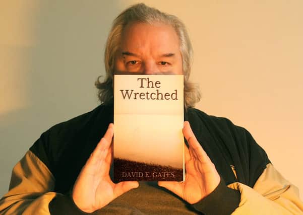 David E Gates with his new book, The Wretched, which was inspired by Portsmouth